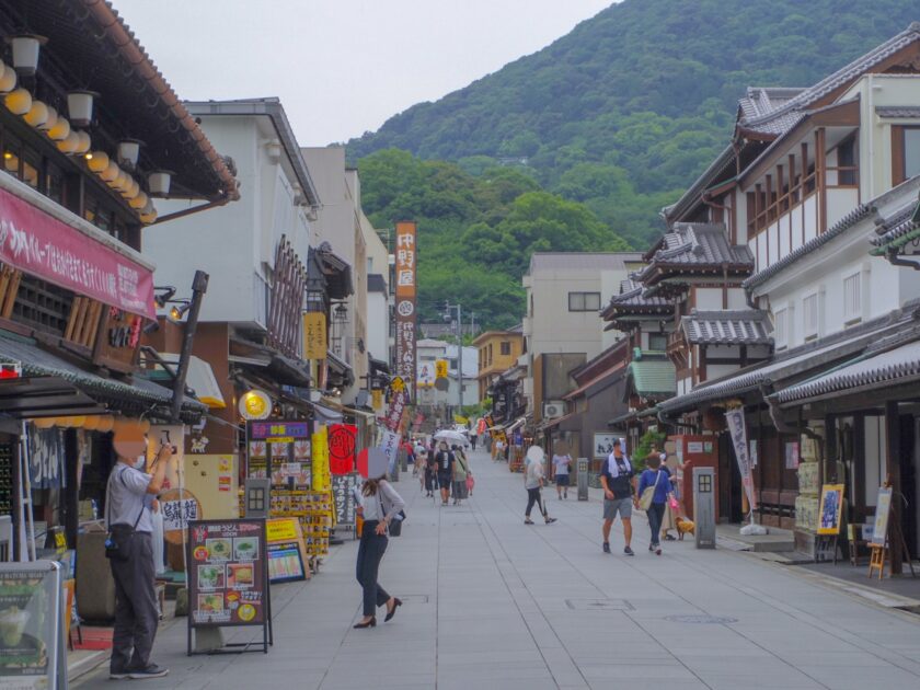 Traditional shopping street leading to Kotohira-gu Shrine with wooden storefronts and lanterns