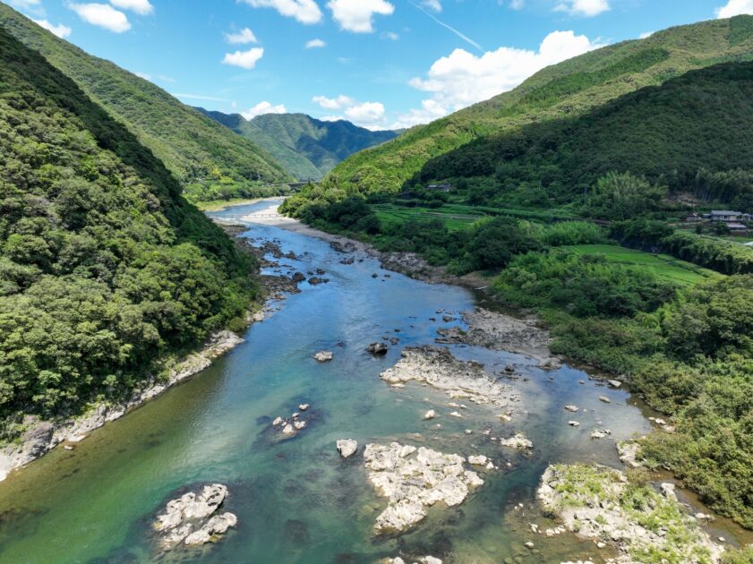 Scenic river winding through green mountains in western Kochi
