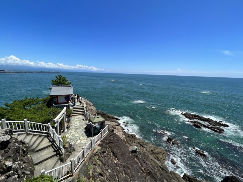 Crescent beach with crashing Pacific waves and rocky headlands Kochi